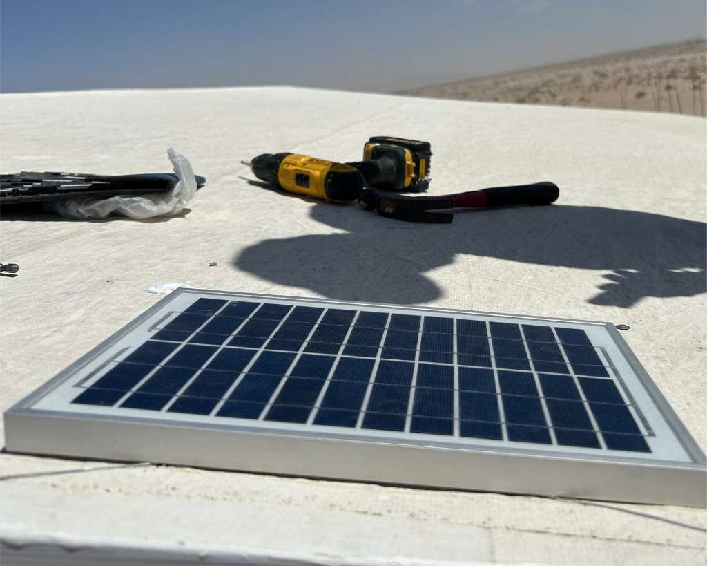 Biolite Solar Panel installed on a roof with a drill beside it